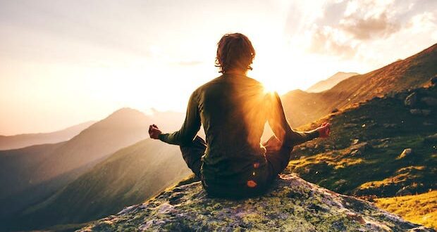 man meditating at sunset in the mountains 620x330 - Ways for Men to Reduce Stress and Boost Mental Health